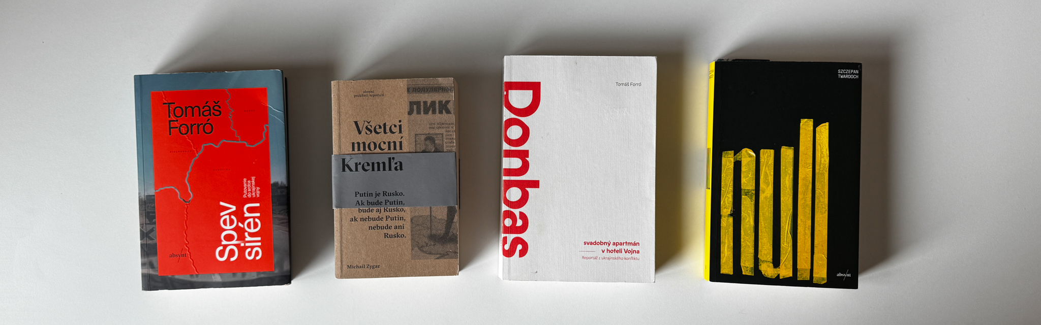 Four books about war against Ukraine on a white table
