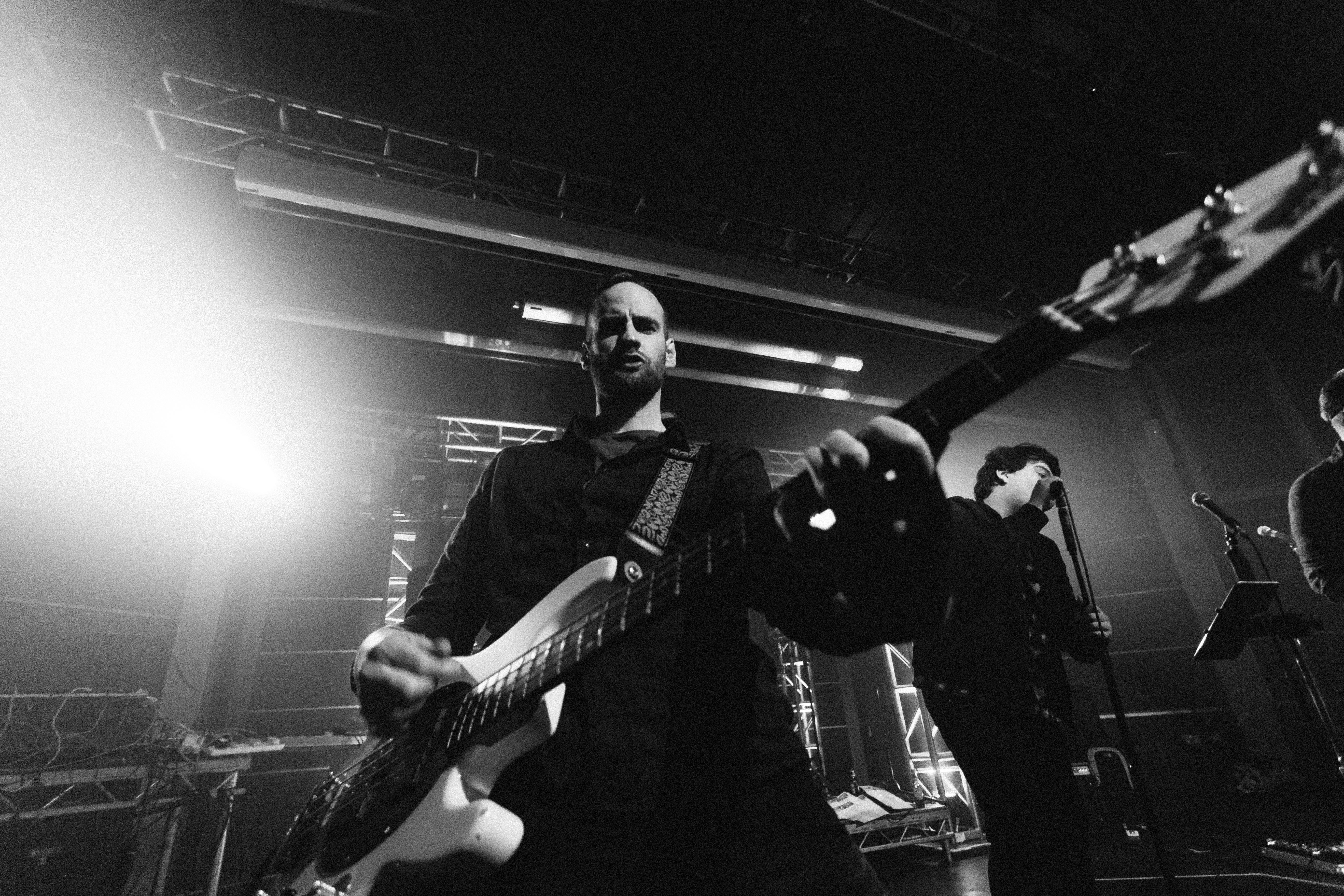 Man playing on a guitar on a concert