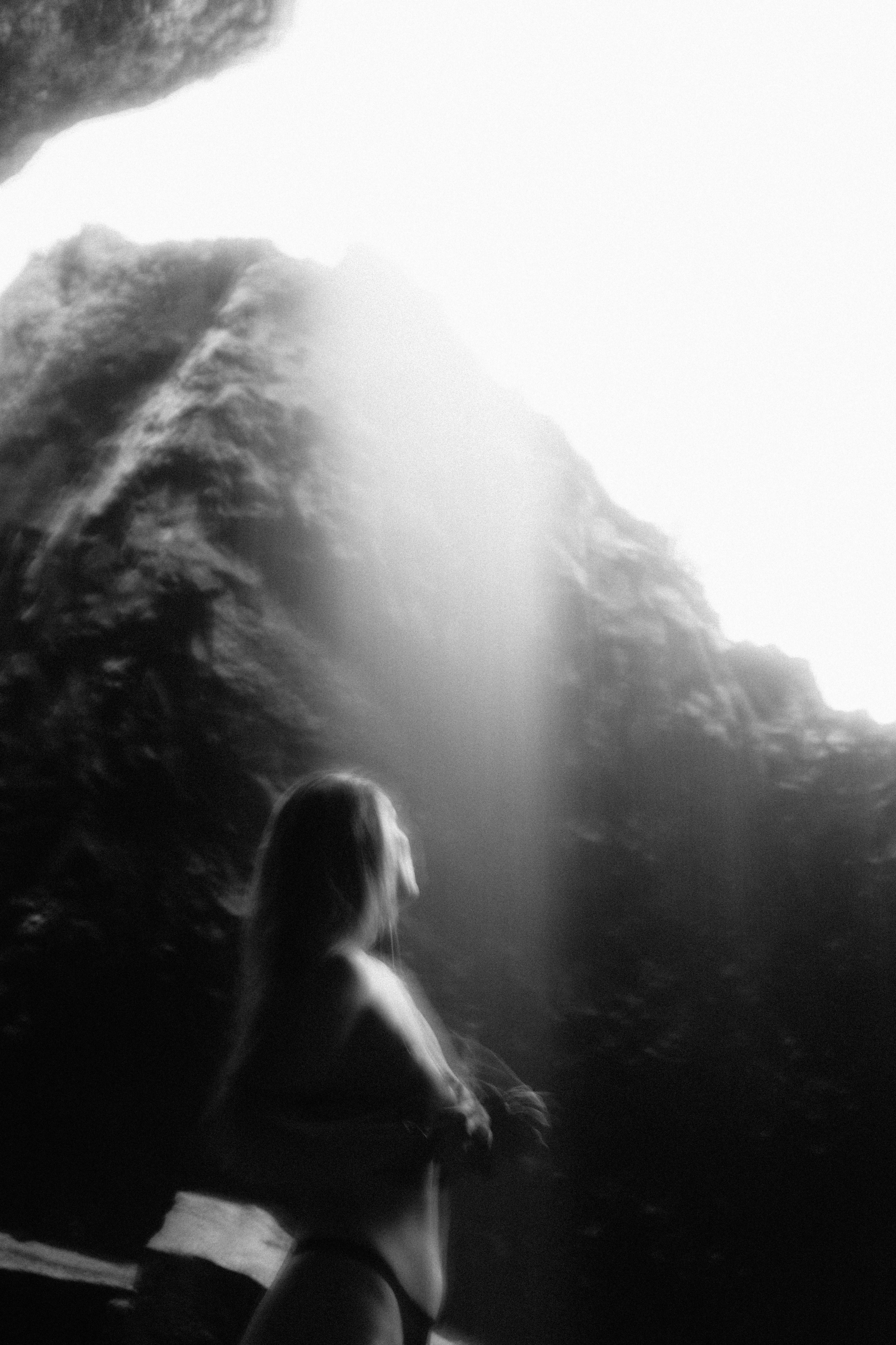 Woman standing under the waterfall